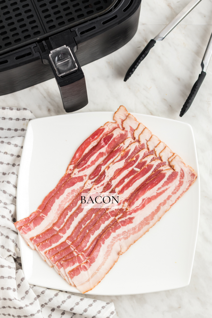 Bacon on a plate on counter beside the air fryer.