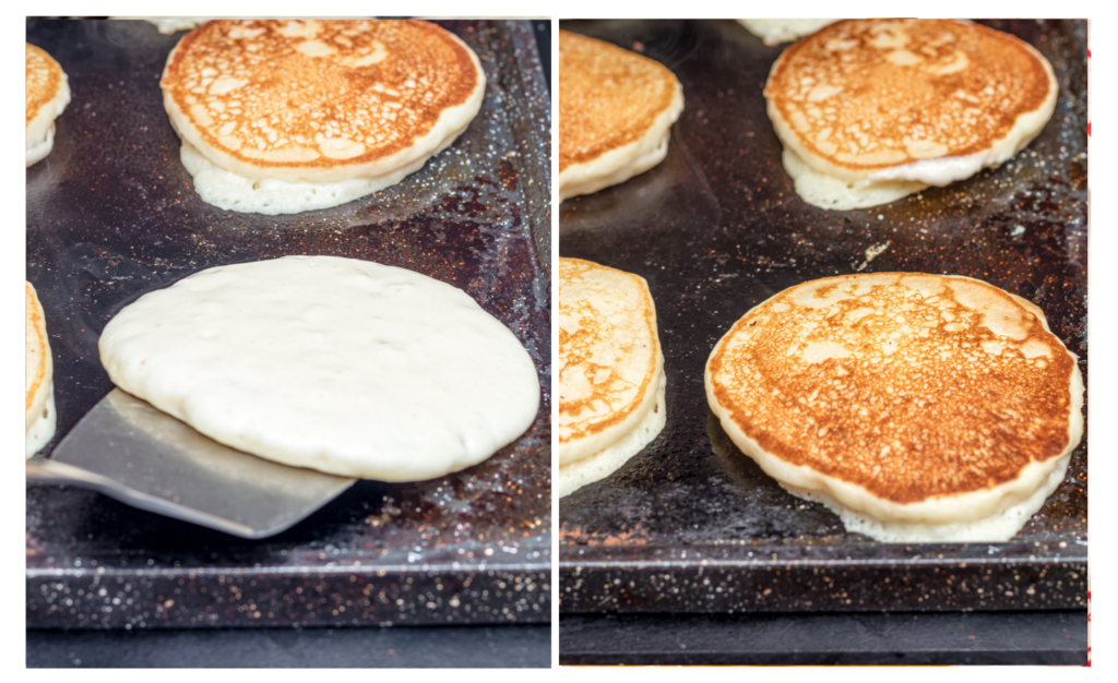 Pancakes on griddle being cooked and flipped with a spatula.