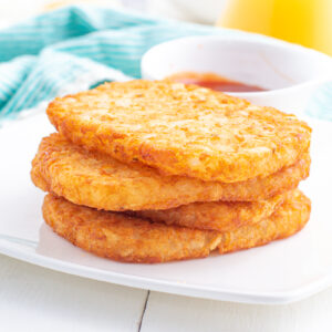 Hash browns stacked on a plate.