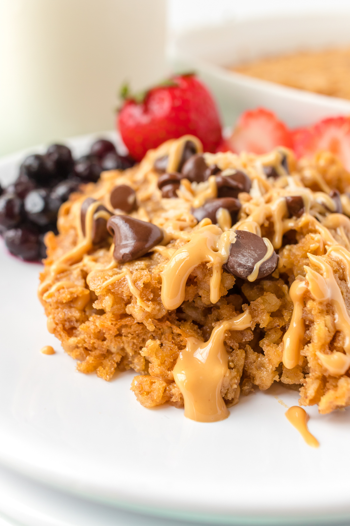 Baked oatmeal with warm drizzled peanut butter and chocolate chips.