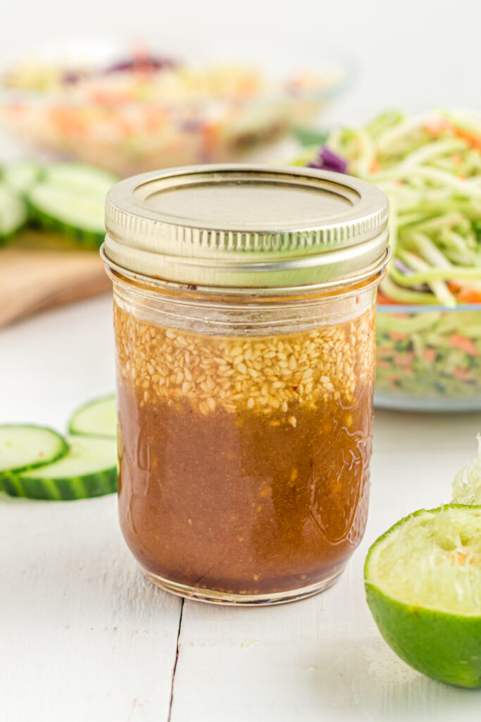 Roasted sesame ginger dressing in a mason jar on table.