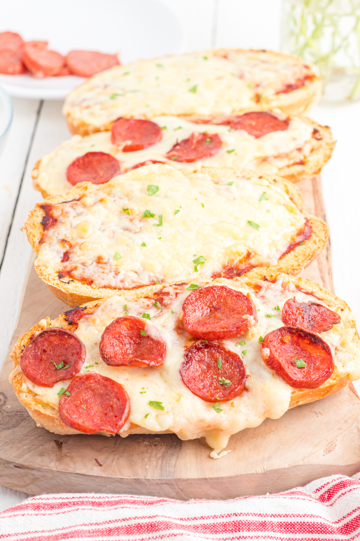 Air Fryer French bed pizza slices on cutting board.