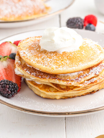 Pancakes with whipped cream and berries.