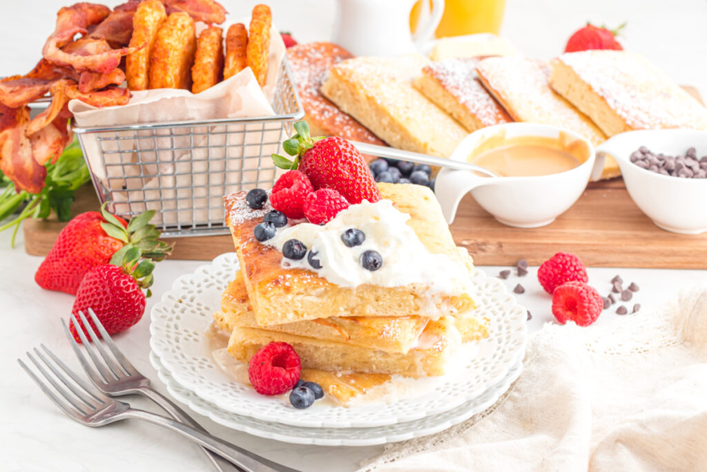 pancakes on plate with toppings on charcuterie board.