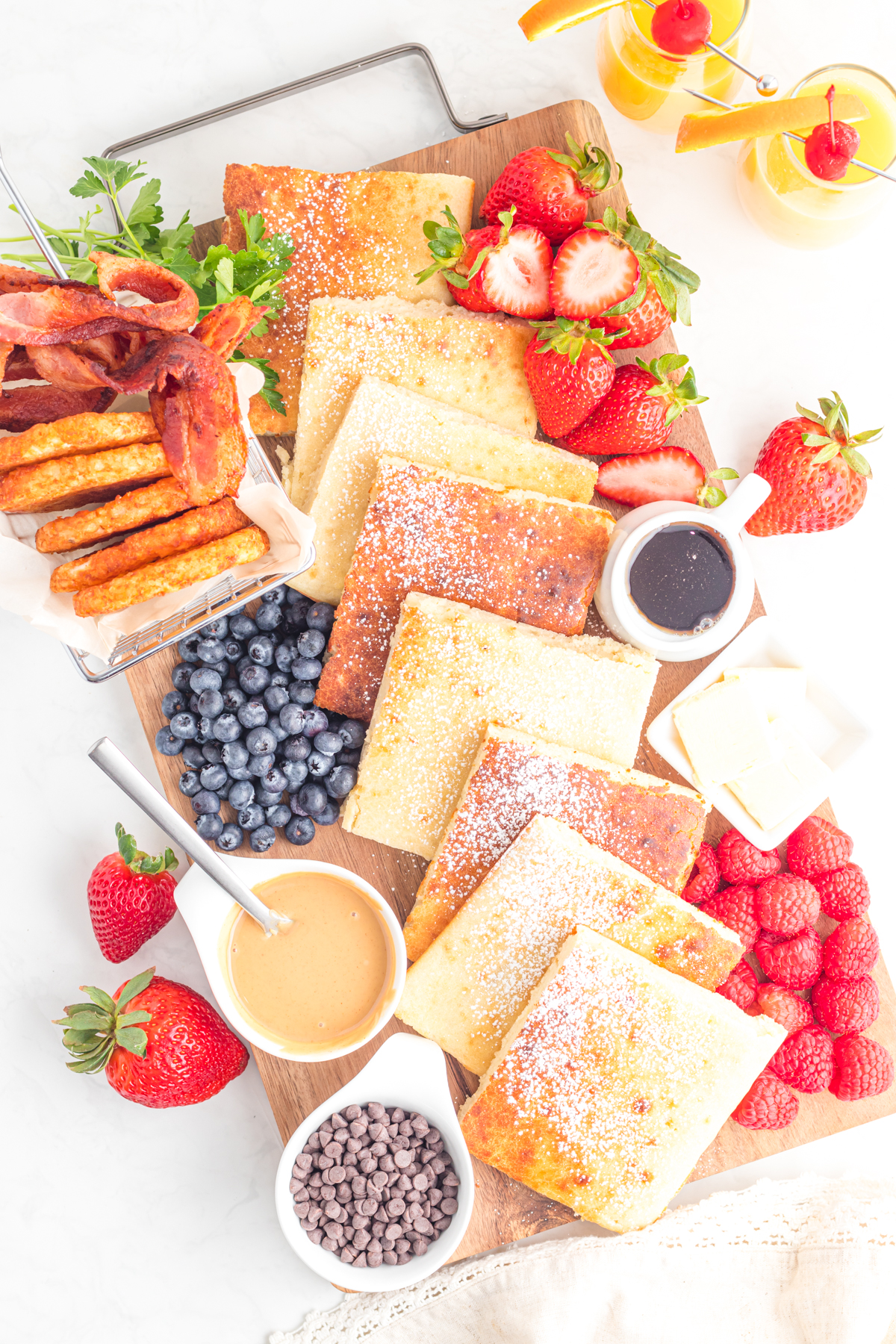 Pancake charcuterie board with berries syrups and butters.