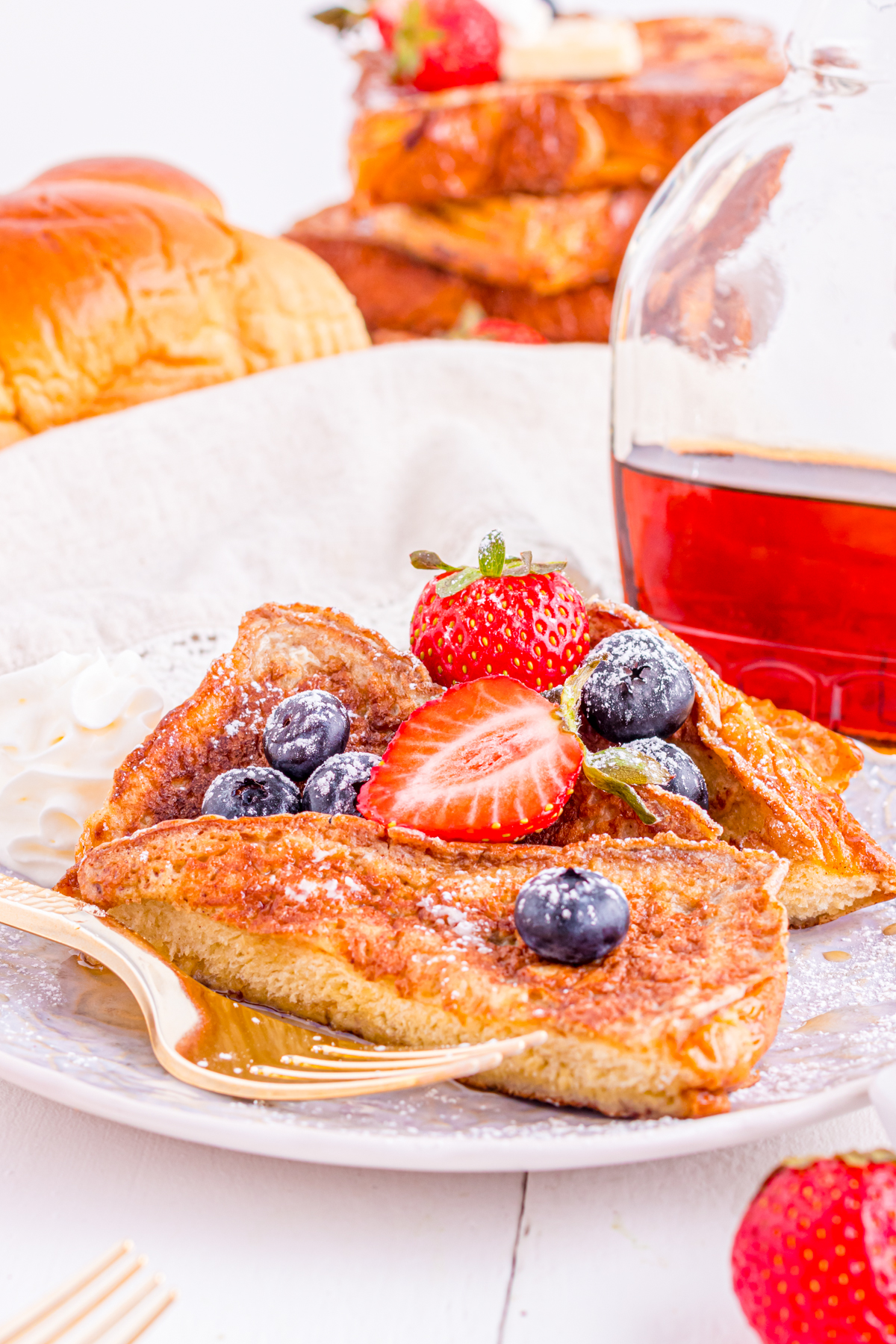French toast slices on a plate with berries.