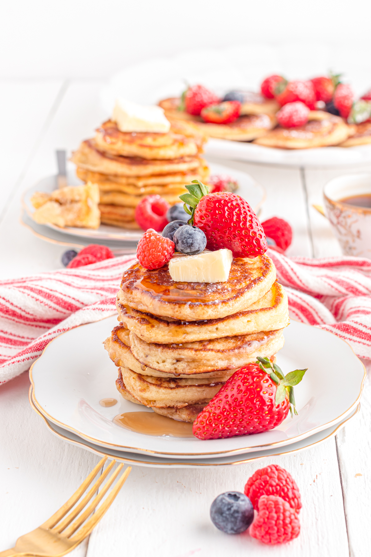 Pancake stack on a plate with berries.