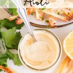 Aioli in a jar surrounded by french fries.