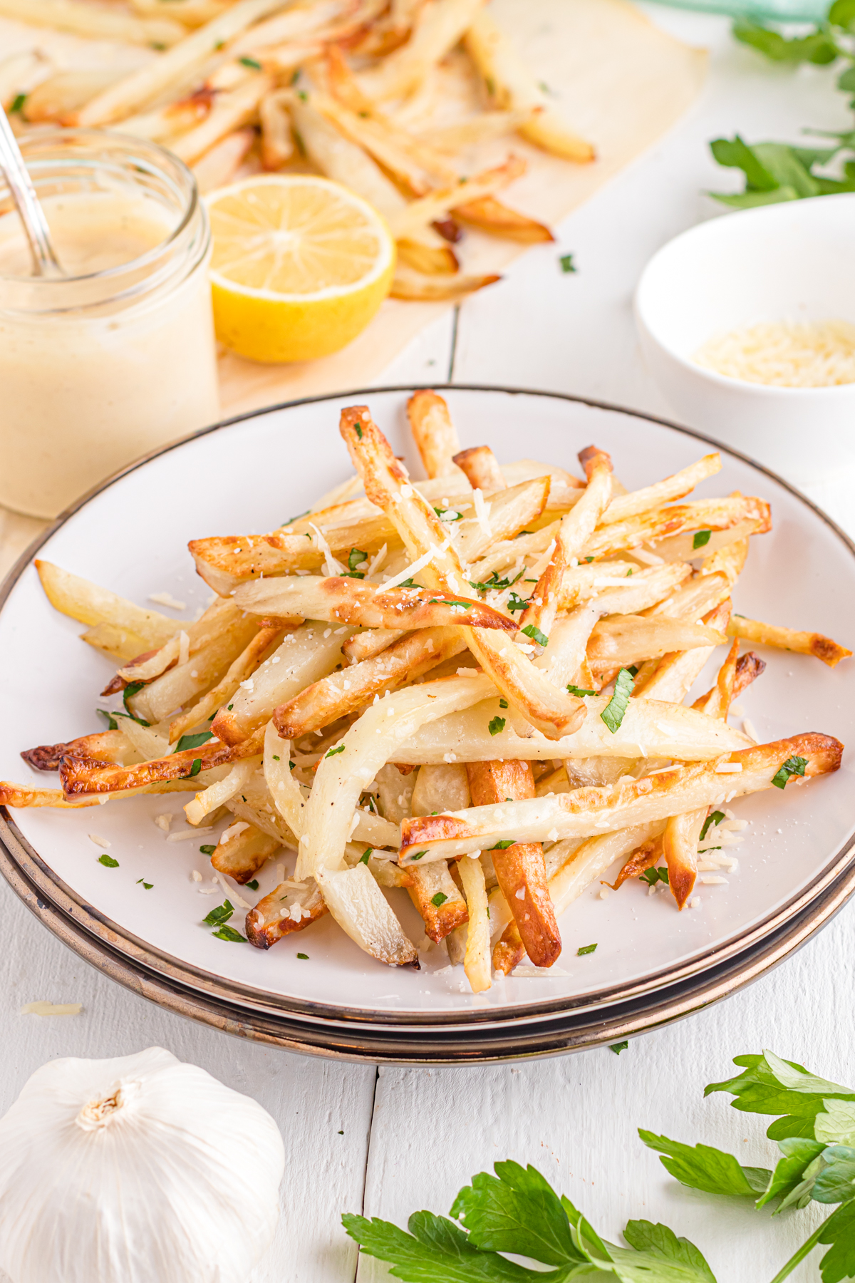Truffle fries on table with garlic and parsley.