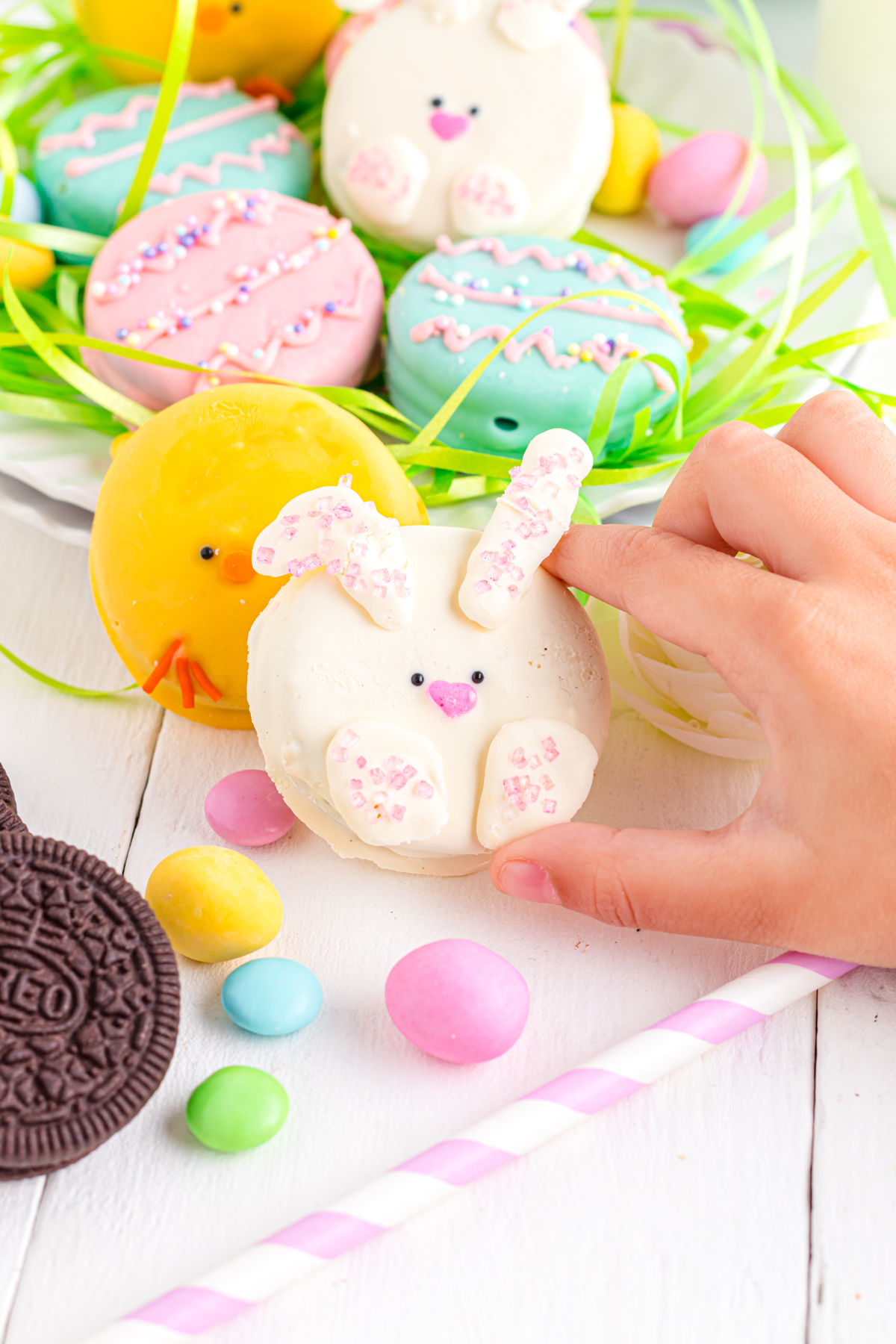 Child's hand holding Easter Bunny Oreo.