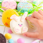 Child's hand holding Easter bunny Oreo.