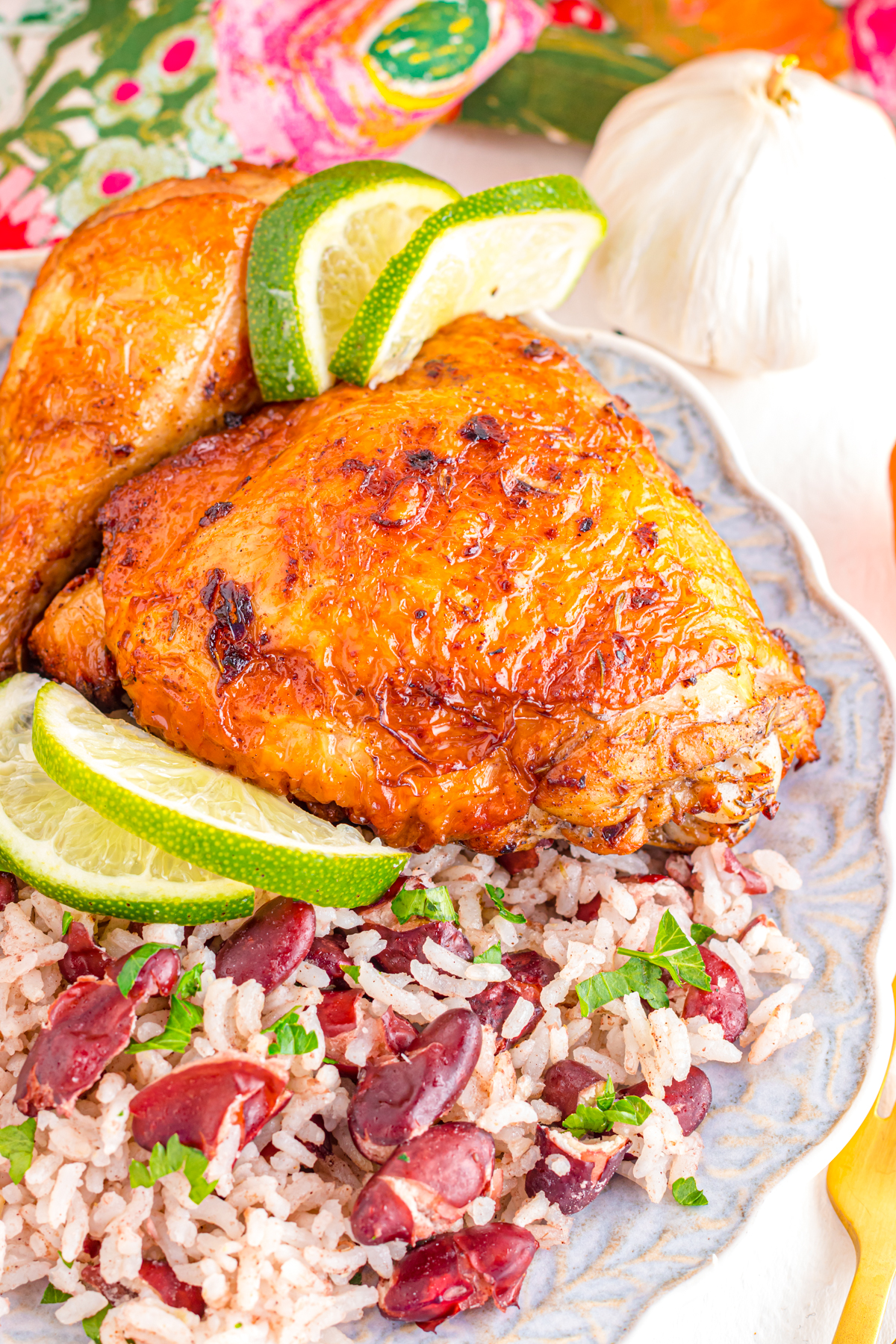 Air fryer jerk chicken on a plate with rice and peas.