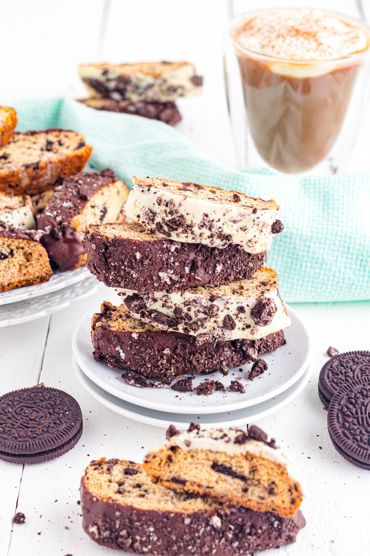 Oreo Biscotti , dipped in chocolate stacked on a plate.