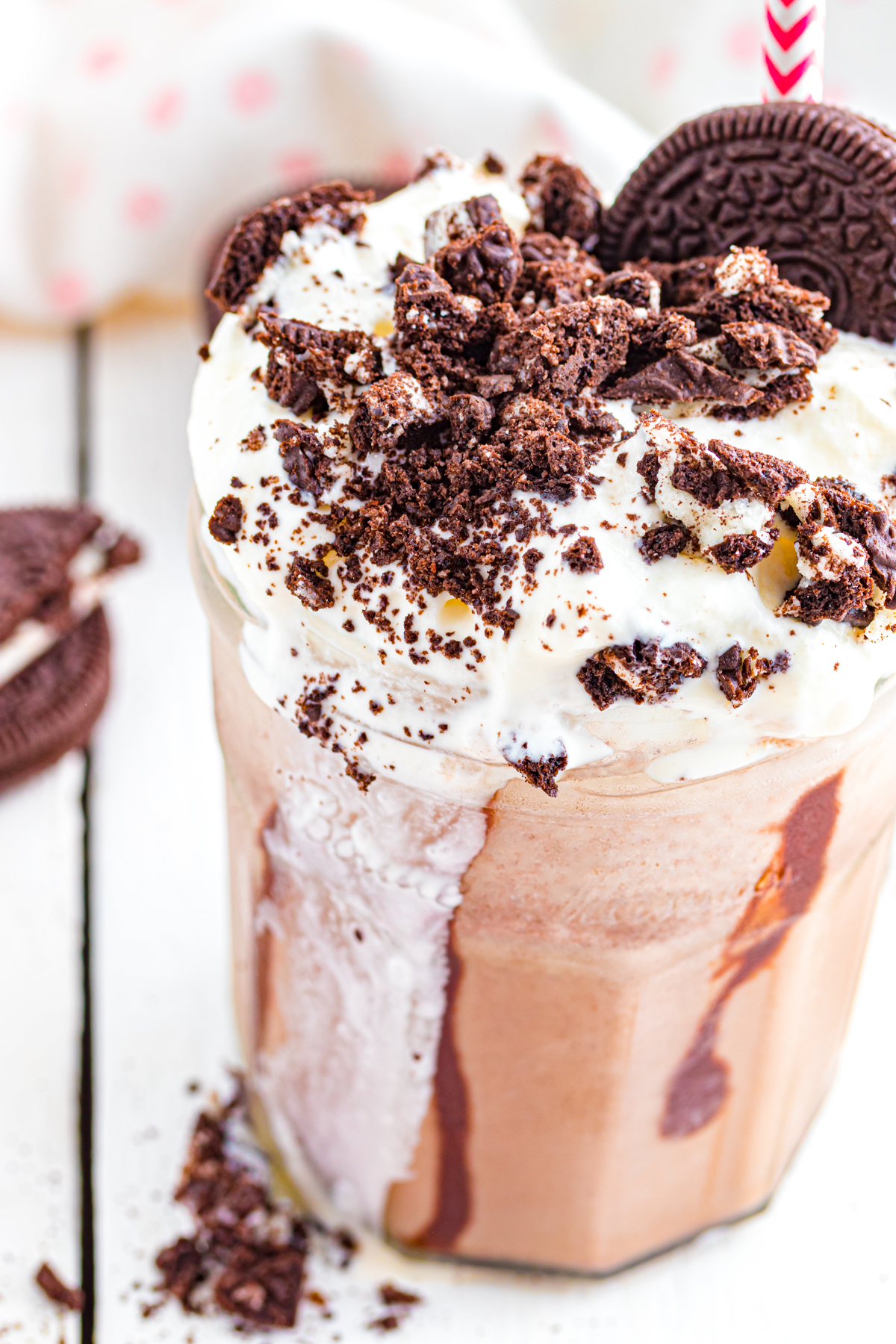 Frappuccino with whipped cream melting and dripping down the glass.