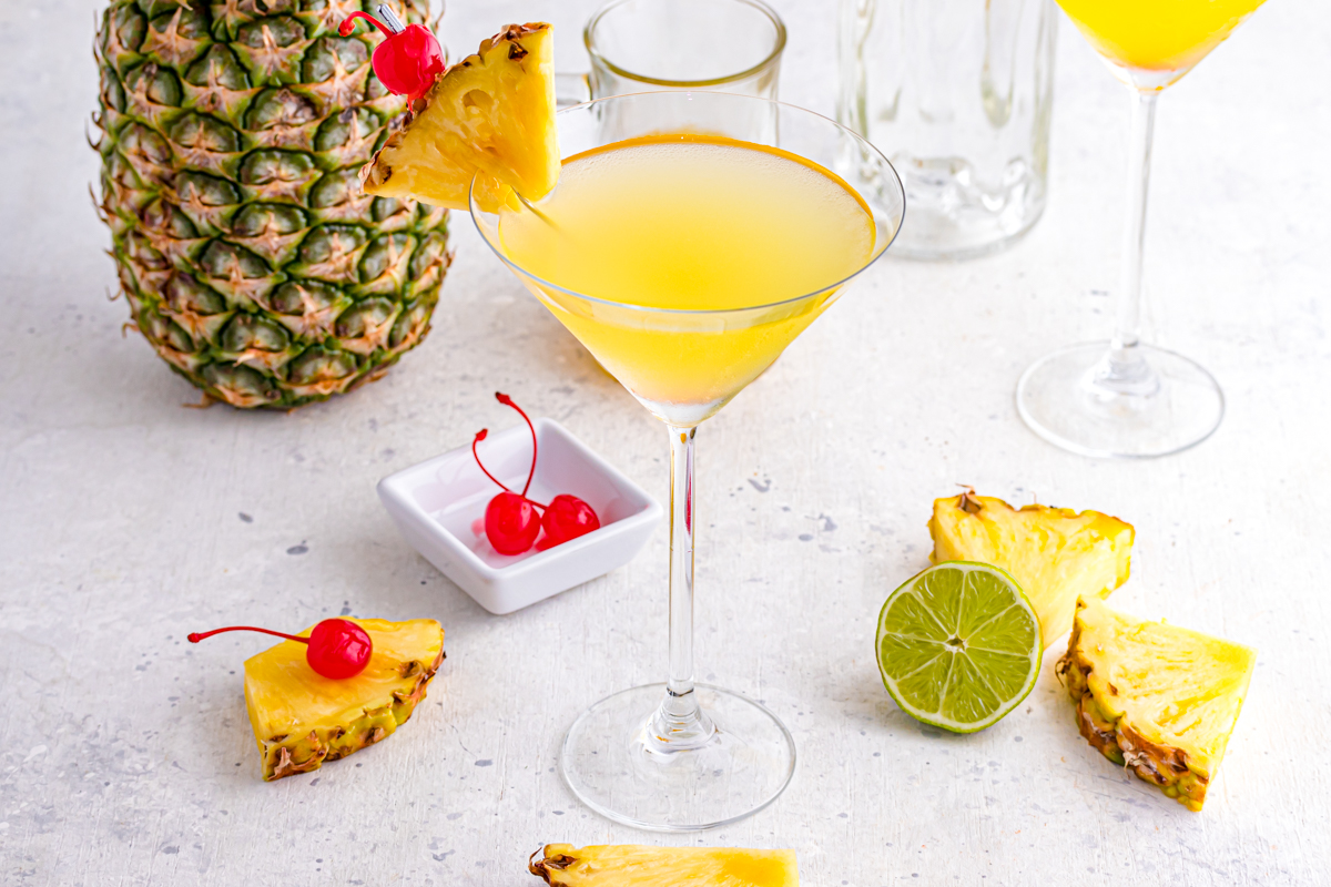 Pineapple Cocktail with garnishes on table.