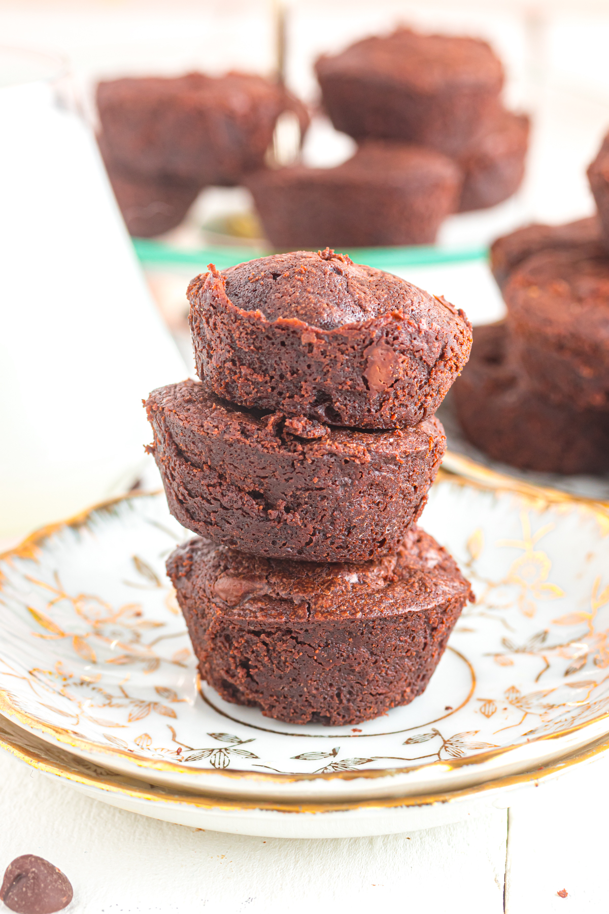 Mini brownie bites stacked on a plate.