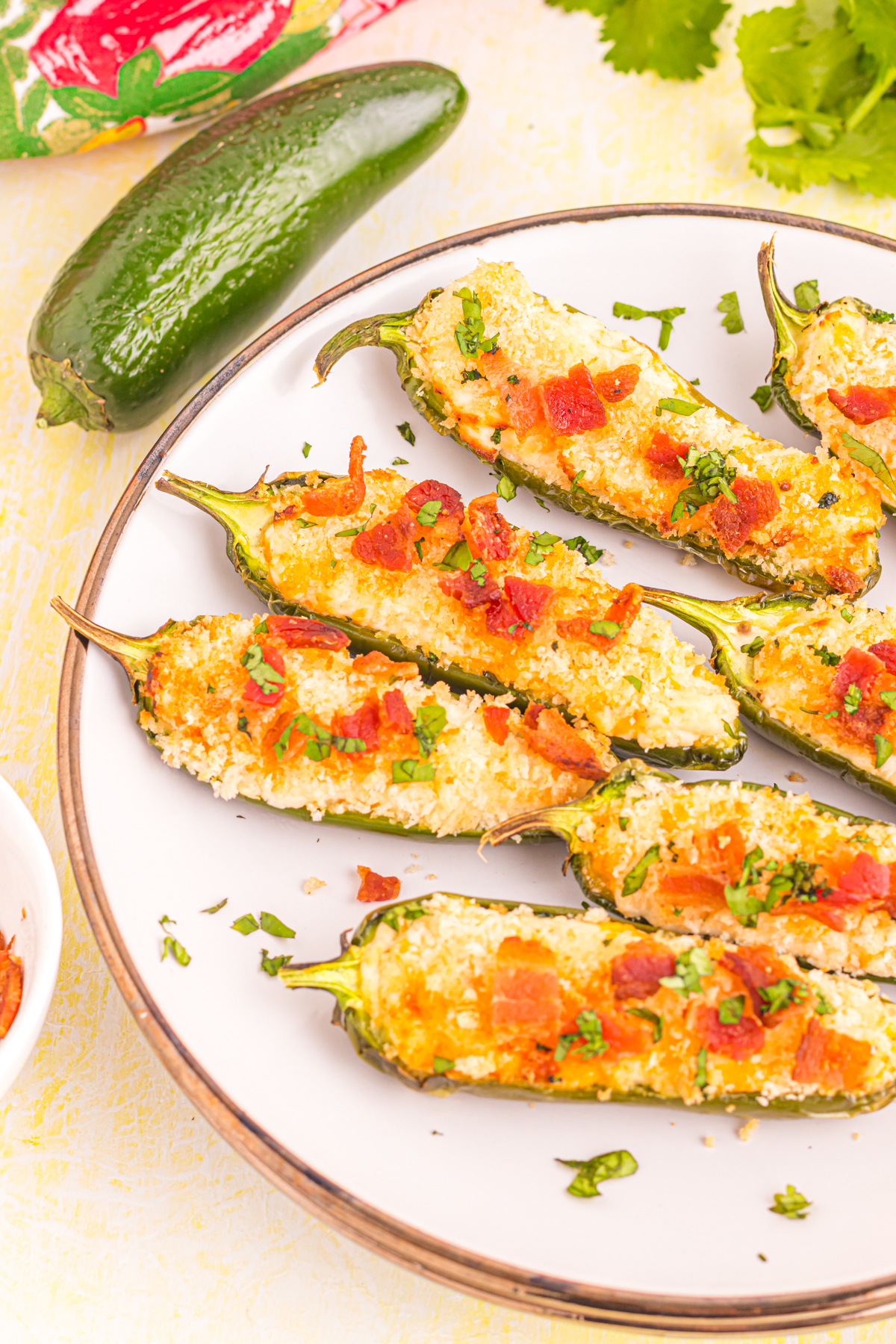 Jalapeno poppers on plate on table.
