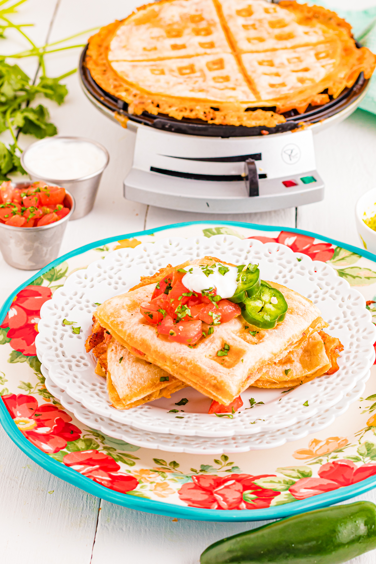 Waffled quesadilla on a plate with toppings.