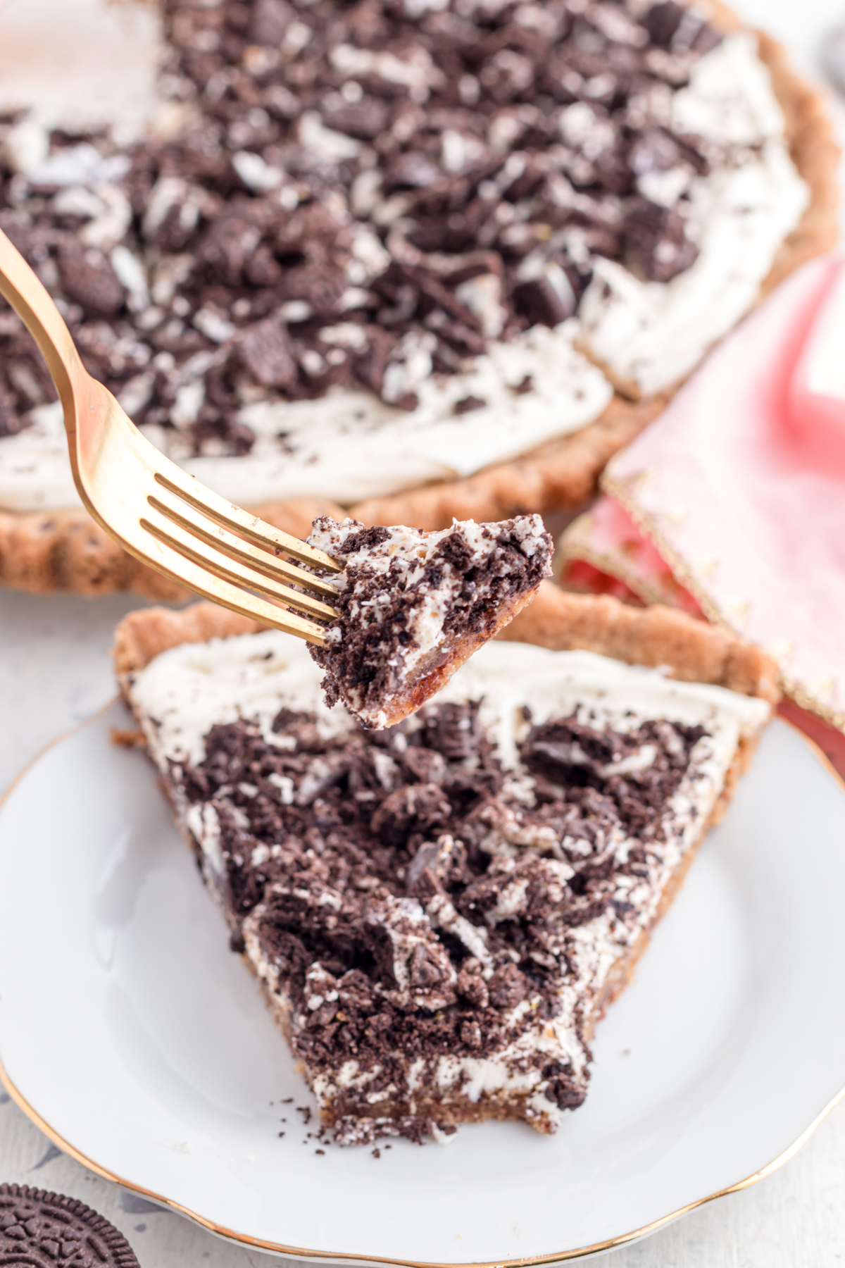 Dessert pizza with Oreos on fork.