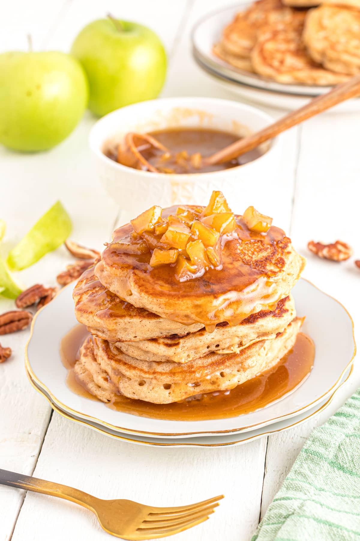 Caramel apple pancakes on table with extra caramel bowl for serving.