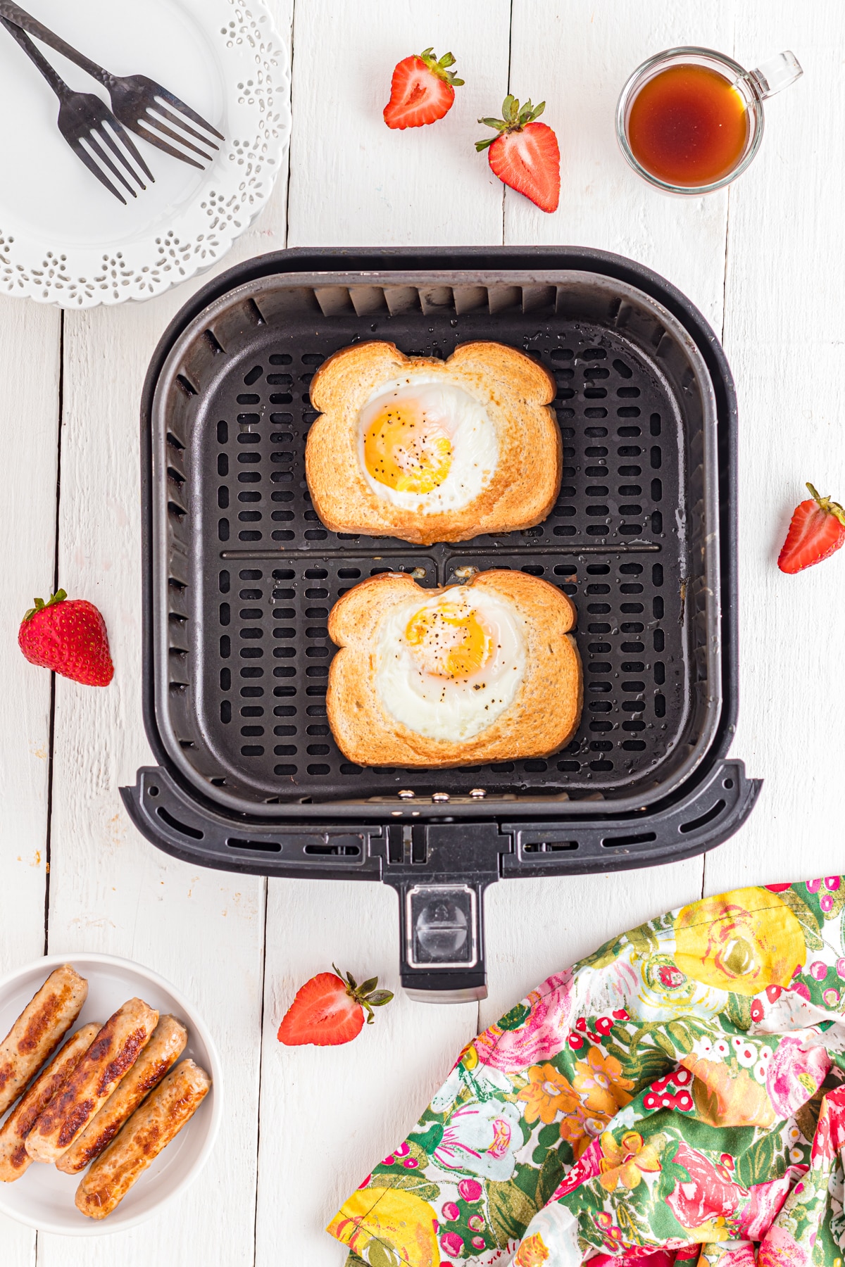 Air fryer egg toast in air fryer basket on table.