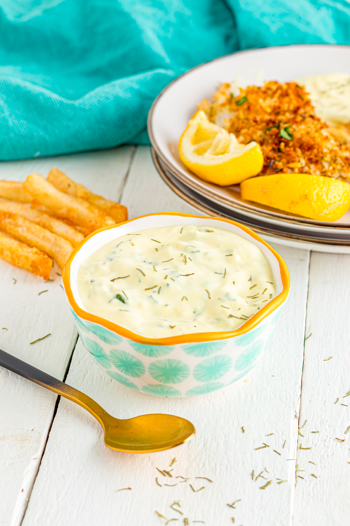 4 ingredient Tartar sauce on a table with fish and chips.