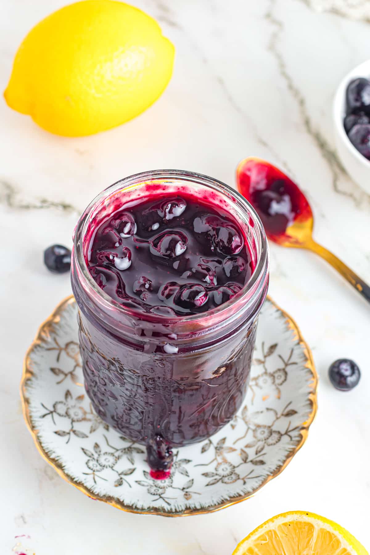 Blueberry compote in mason jar on table.