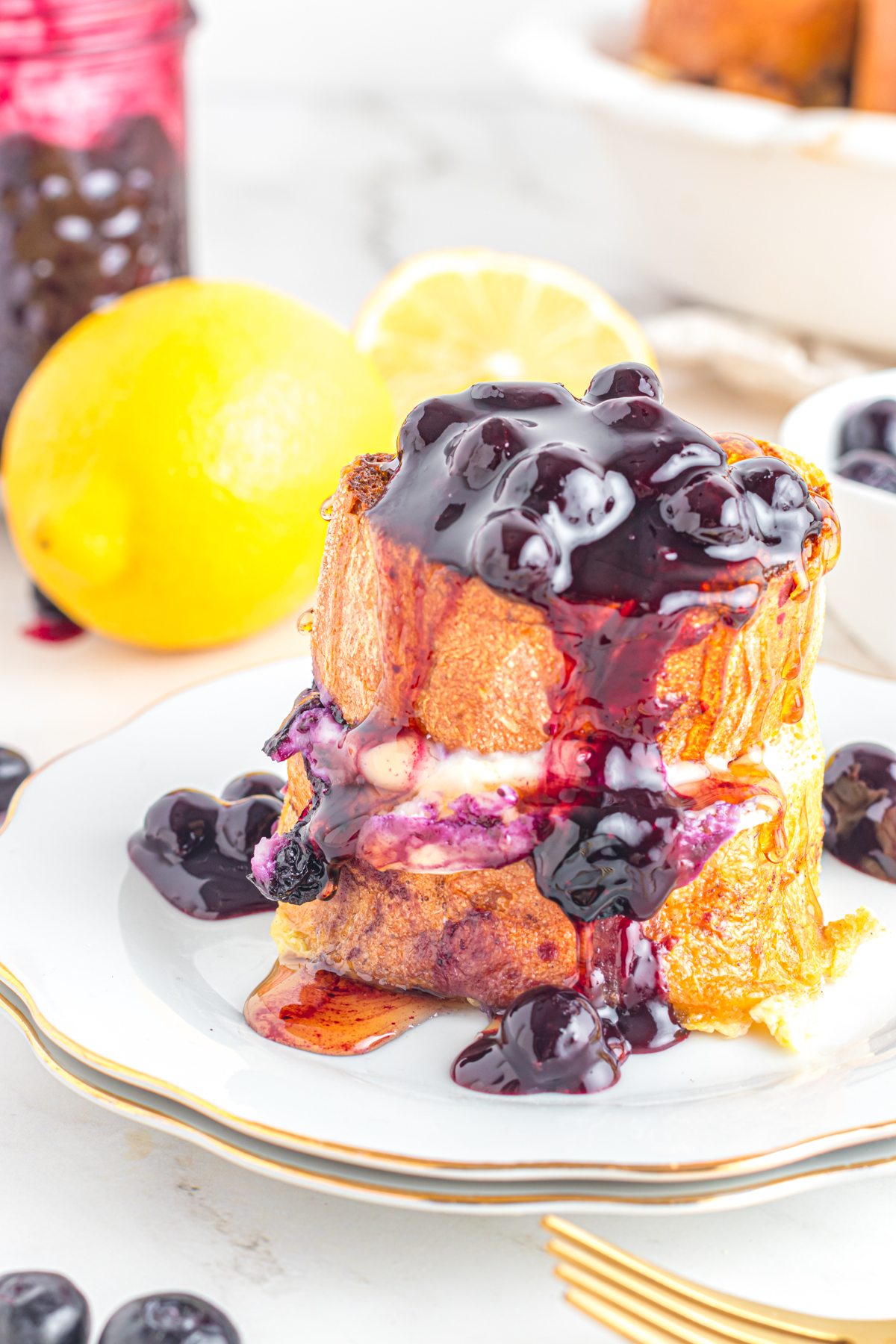 Blueberry stuffed French Toast on a plate with a gold fork!