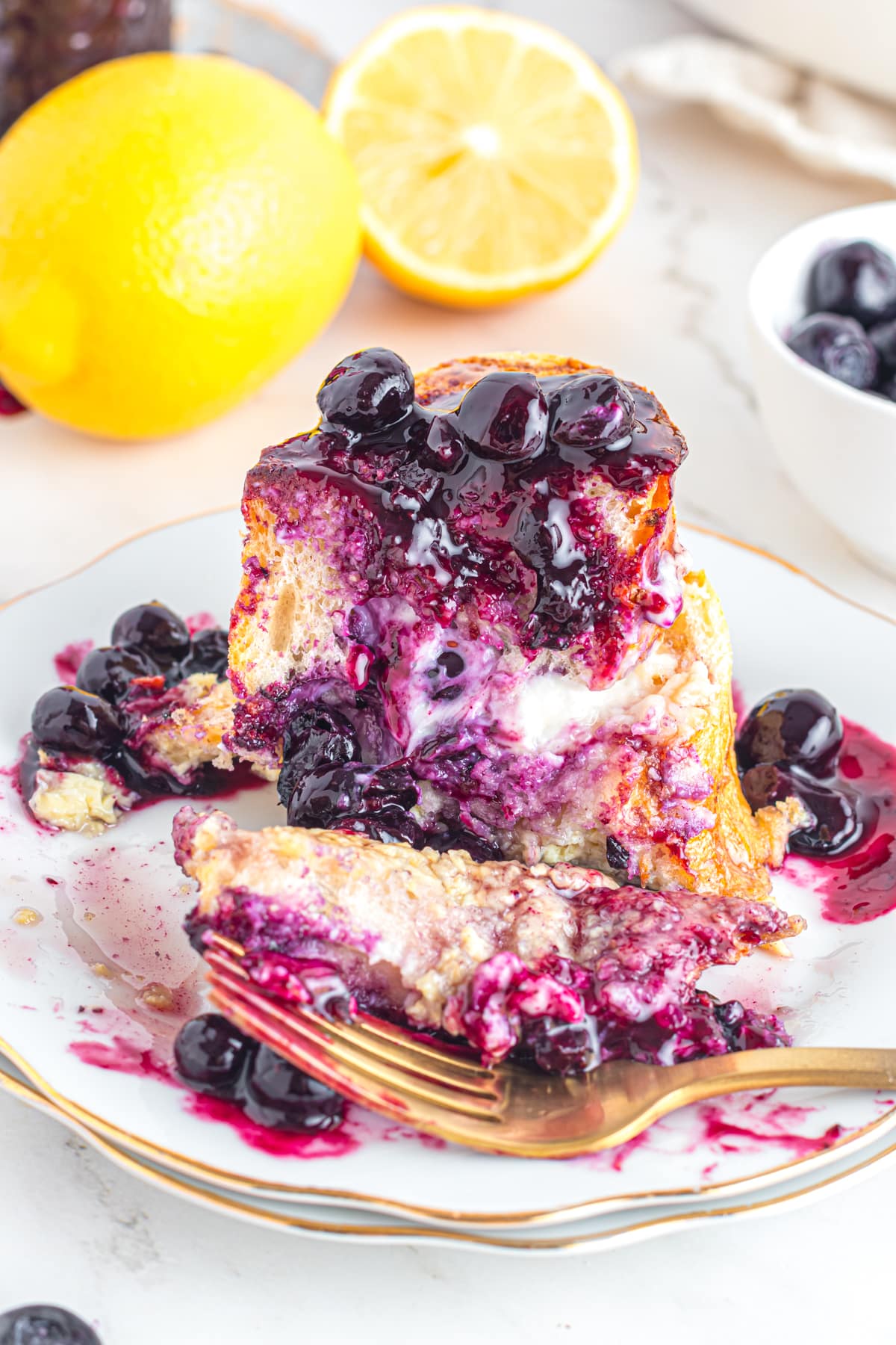 Sliced blueberry French toast revealing cream cheese filling.
