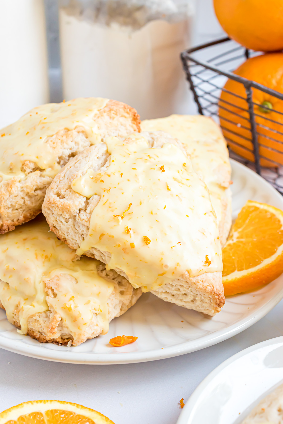 Glazed orange scones on plate.
