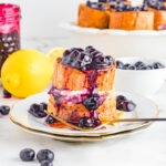 Stuffed blueberry French toast on plate with gold fork.