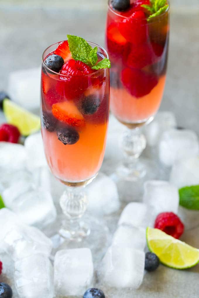 Champagne punch with berries in champagne flute.