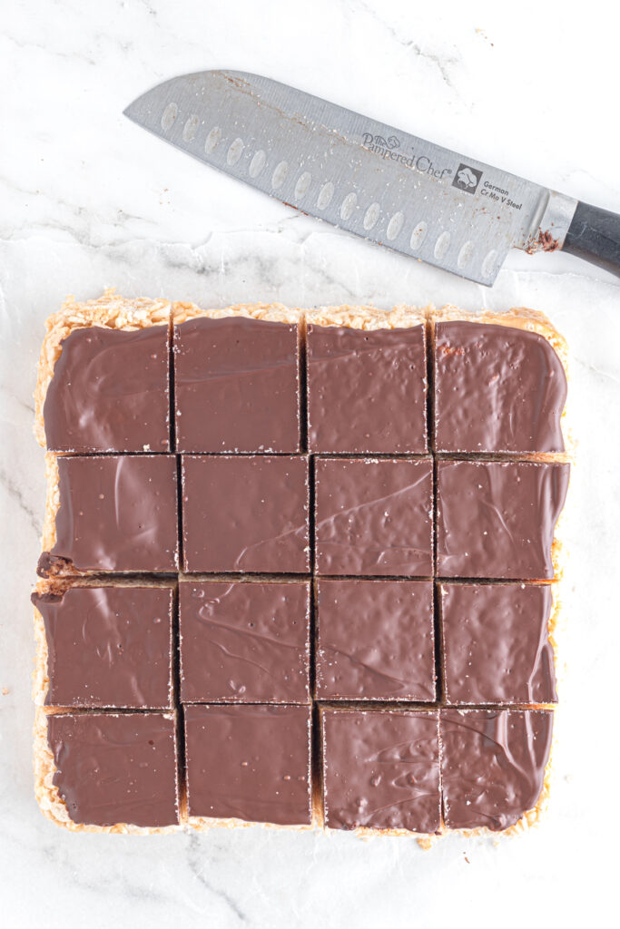 Chocolate covered rice krispie treats cut into squares.