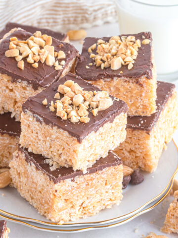 Chocolate Peanut Butter Rice Krispie Treats stacked on a plate.