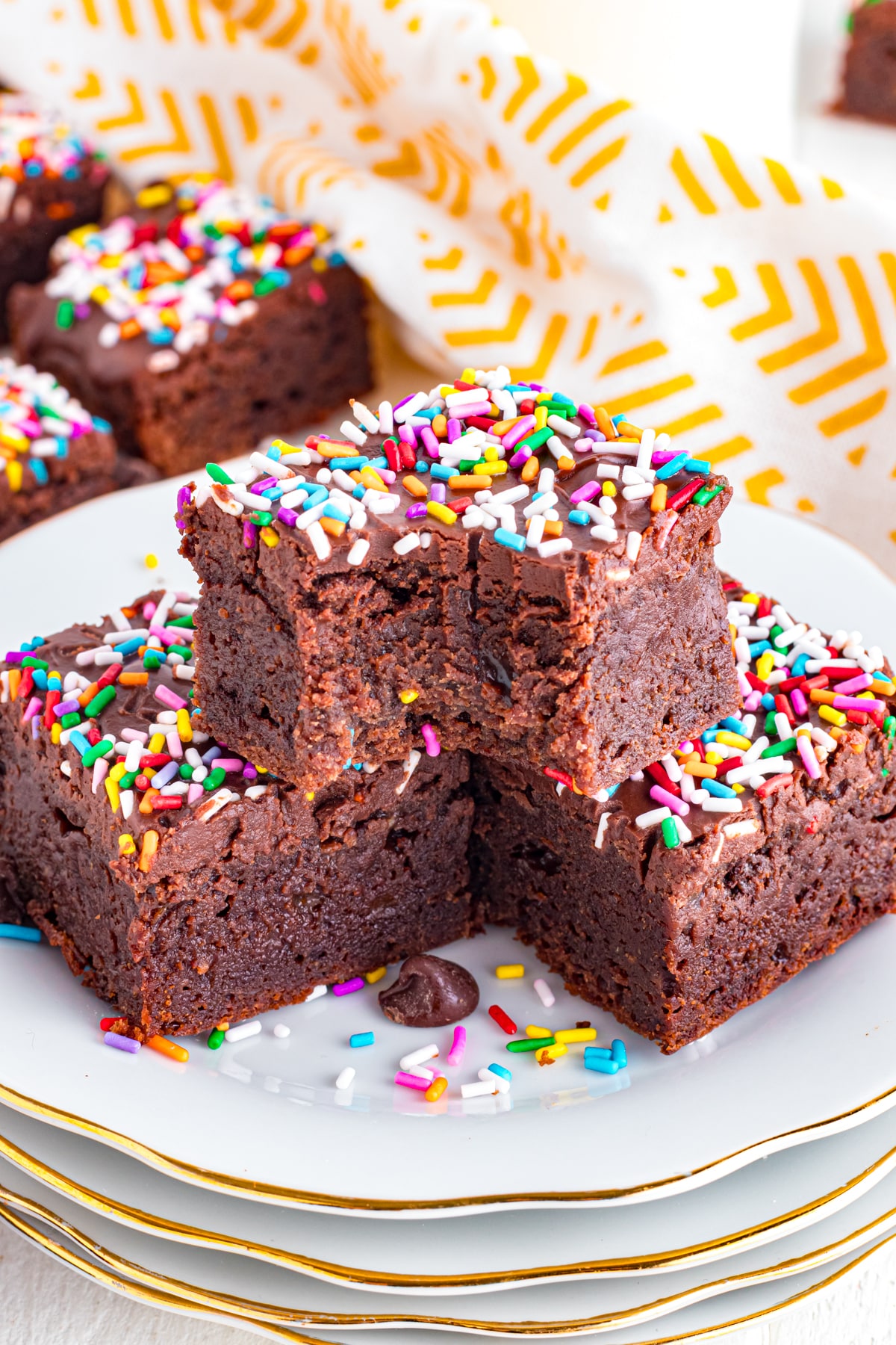 Sprinkle brownies stacked with bite out.