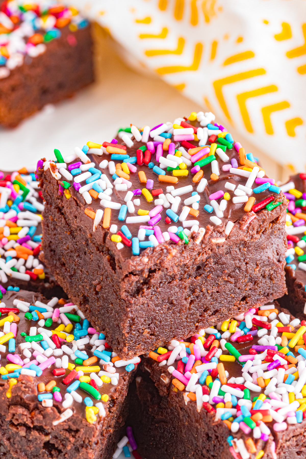 Close up of brownie with ganache icing and sprinkles.