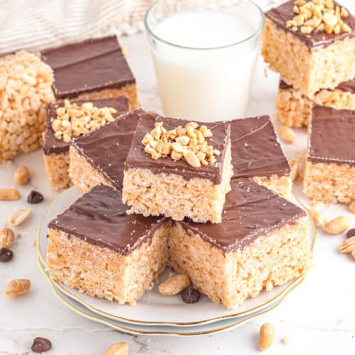 Peanut butter and chocolate rice krispie treats on plate. on table.