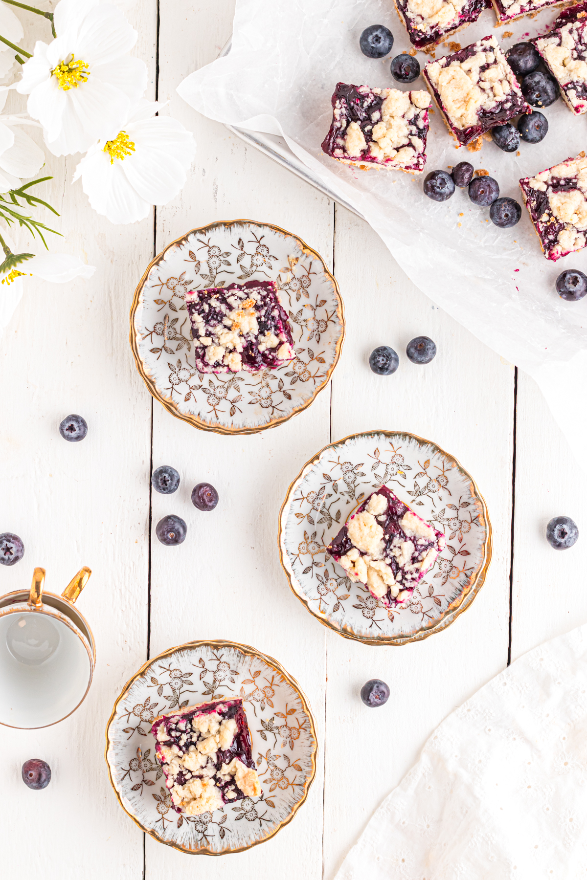 Blueberry bars on plates on table.