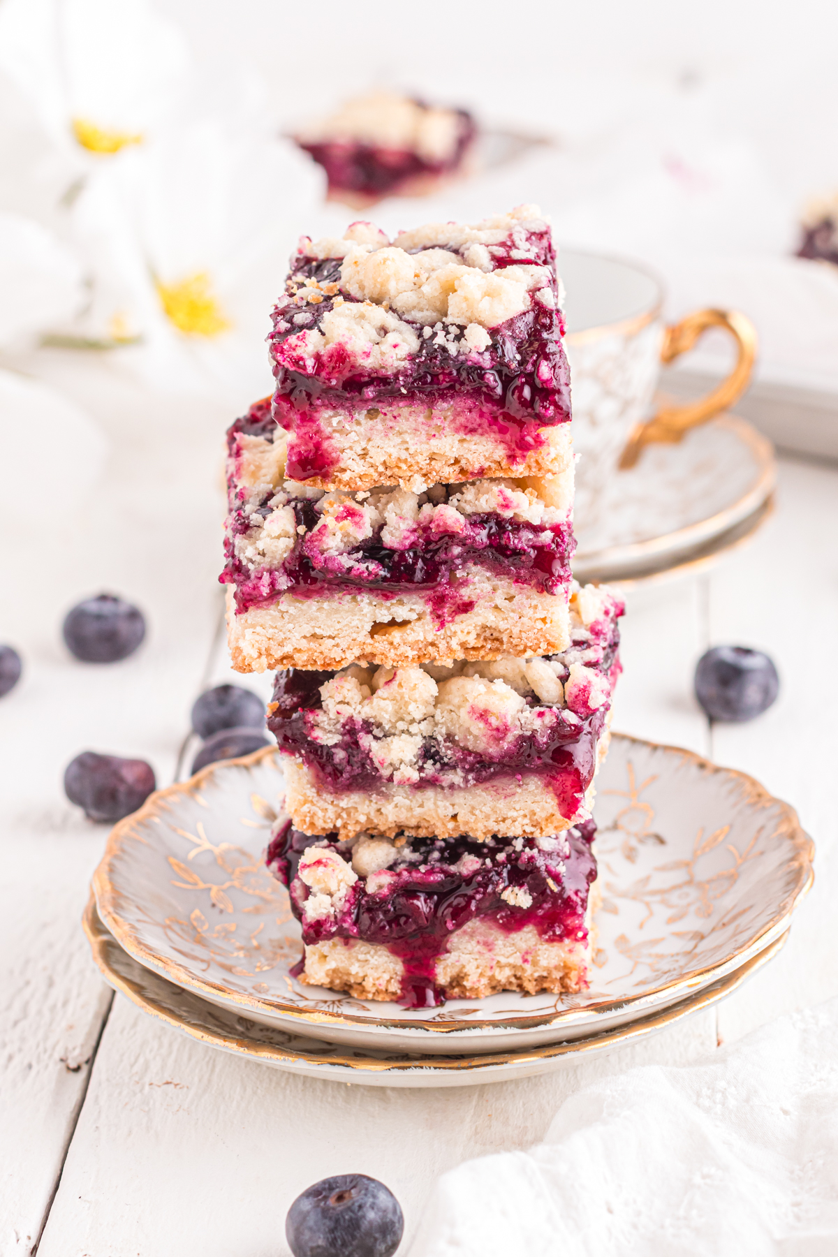 Blueberry bars stacked on an ornate plate.