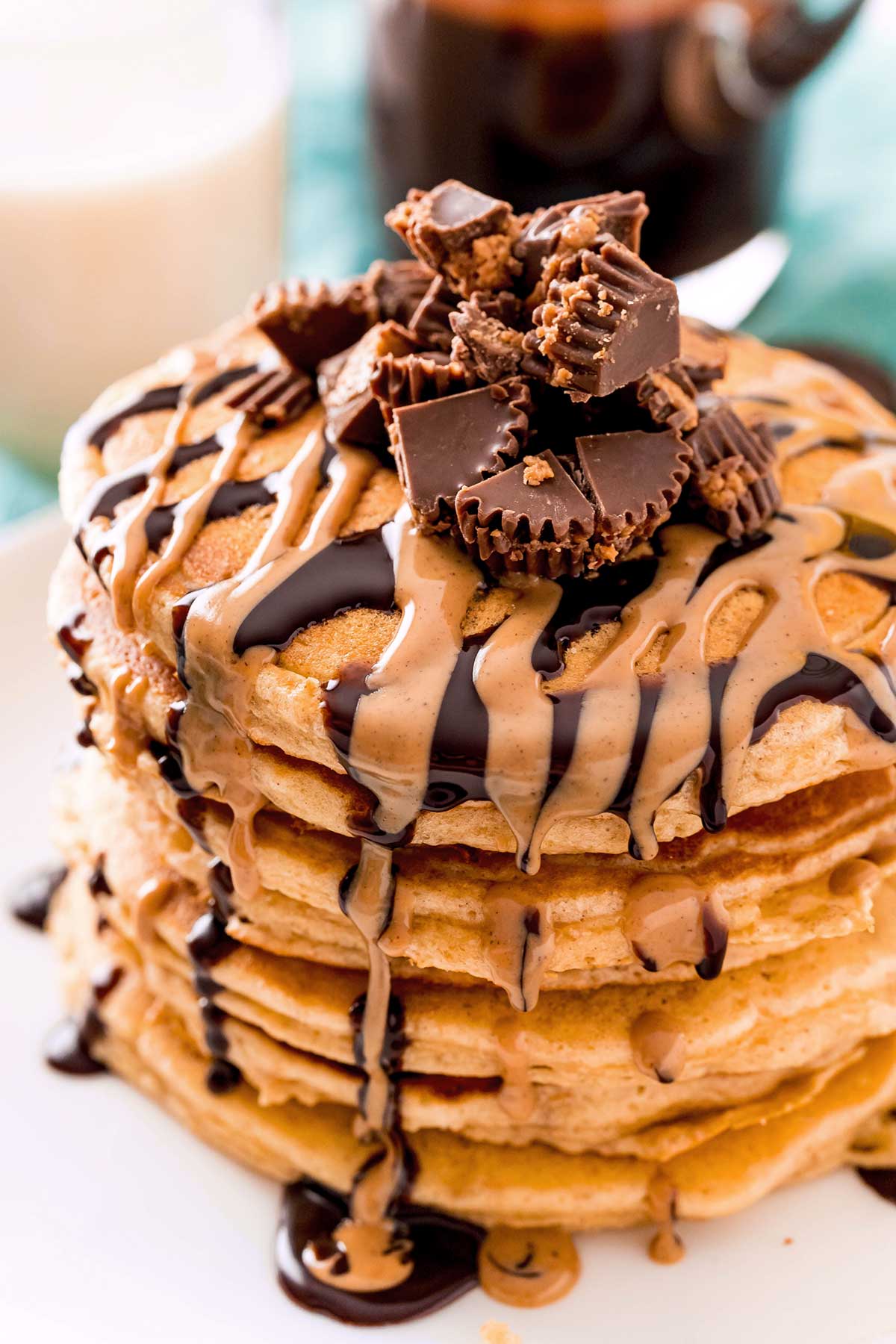 PEANUT BUTTER PANCAKES DRIZZLED WITH CHOCOLATE SAUCE AND PEANUT BUTTER.