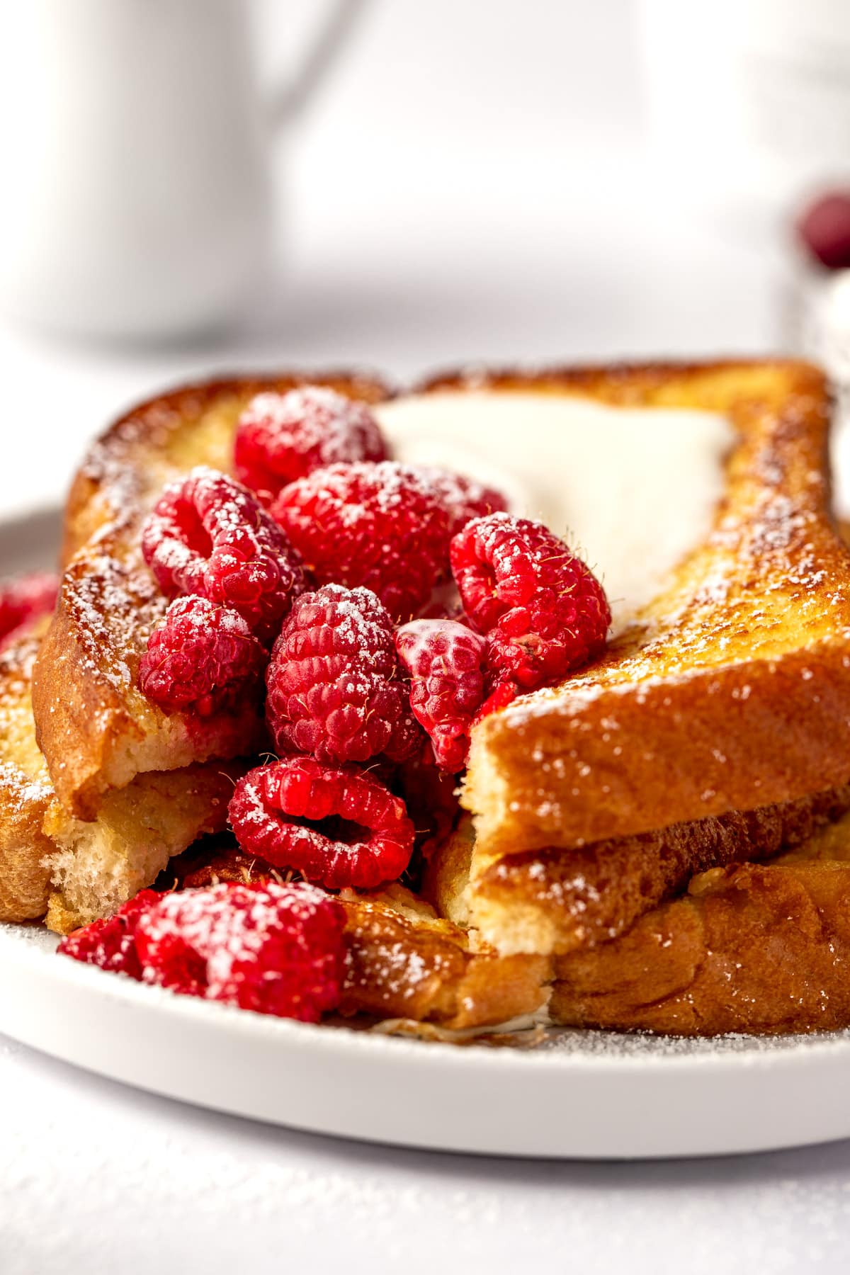 French toast with raspberries on plate.