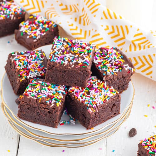 Sprinkle Brownies stacked on a plate.