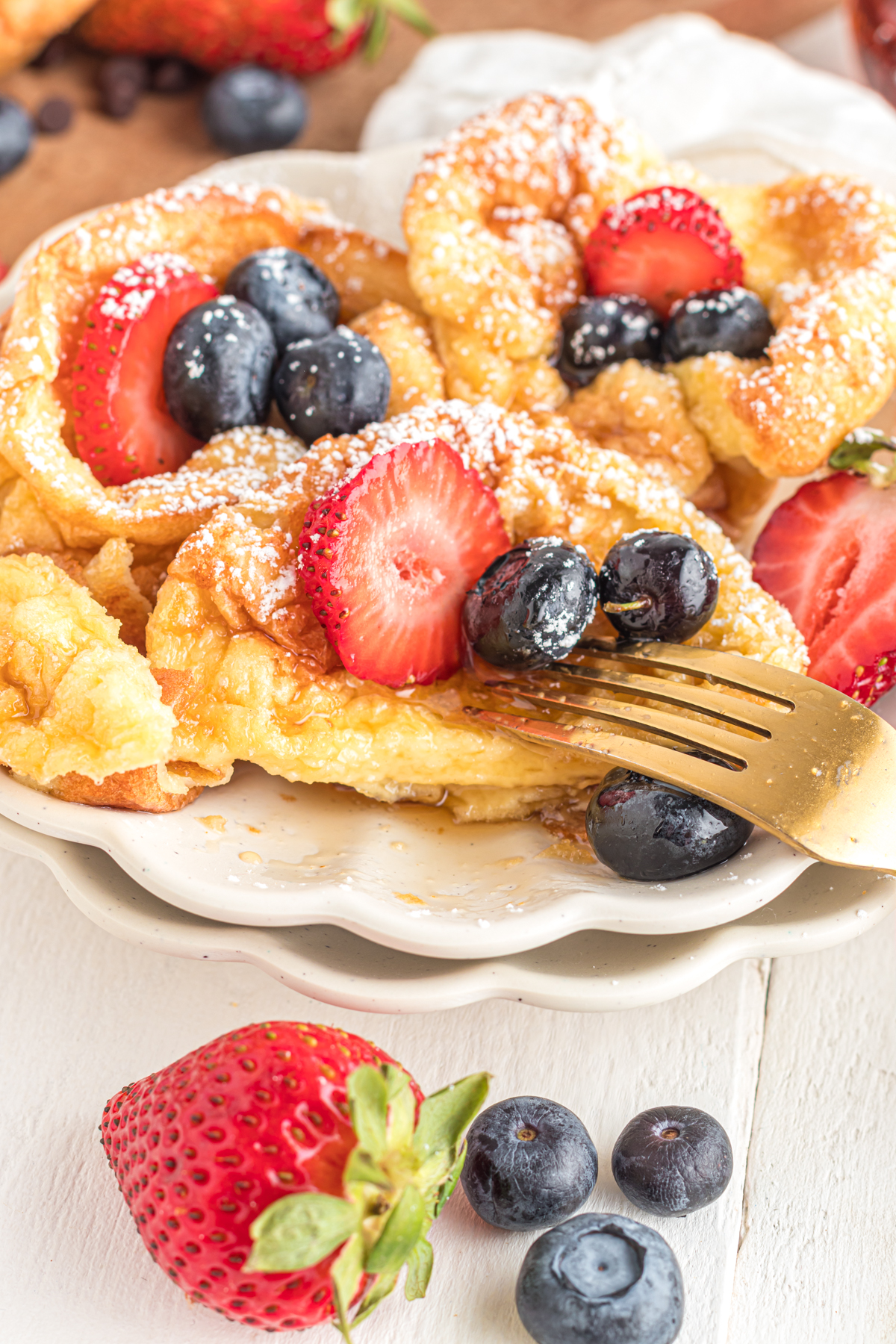 Mini dutch baby cut in half with fork.