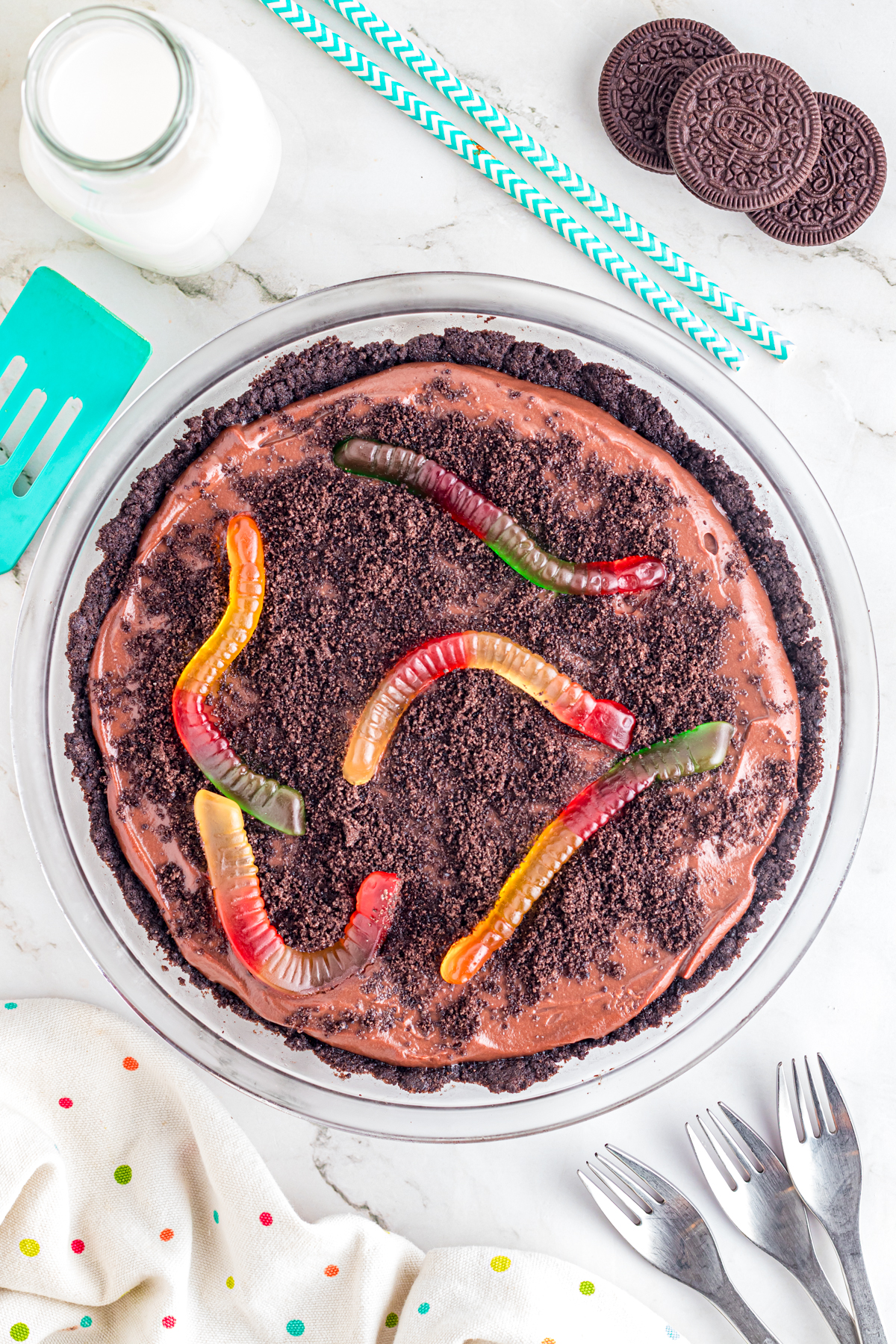 Dirt pie on table with forks and milk.