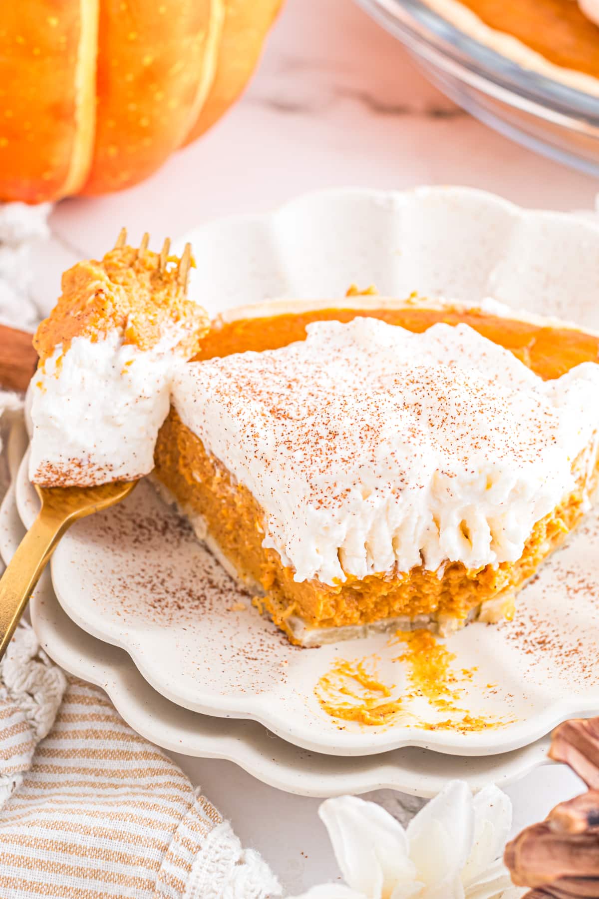 Pumpkin cream pie with bite on fork.