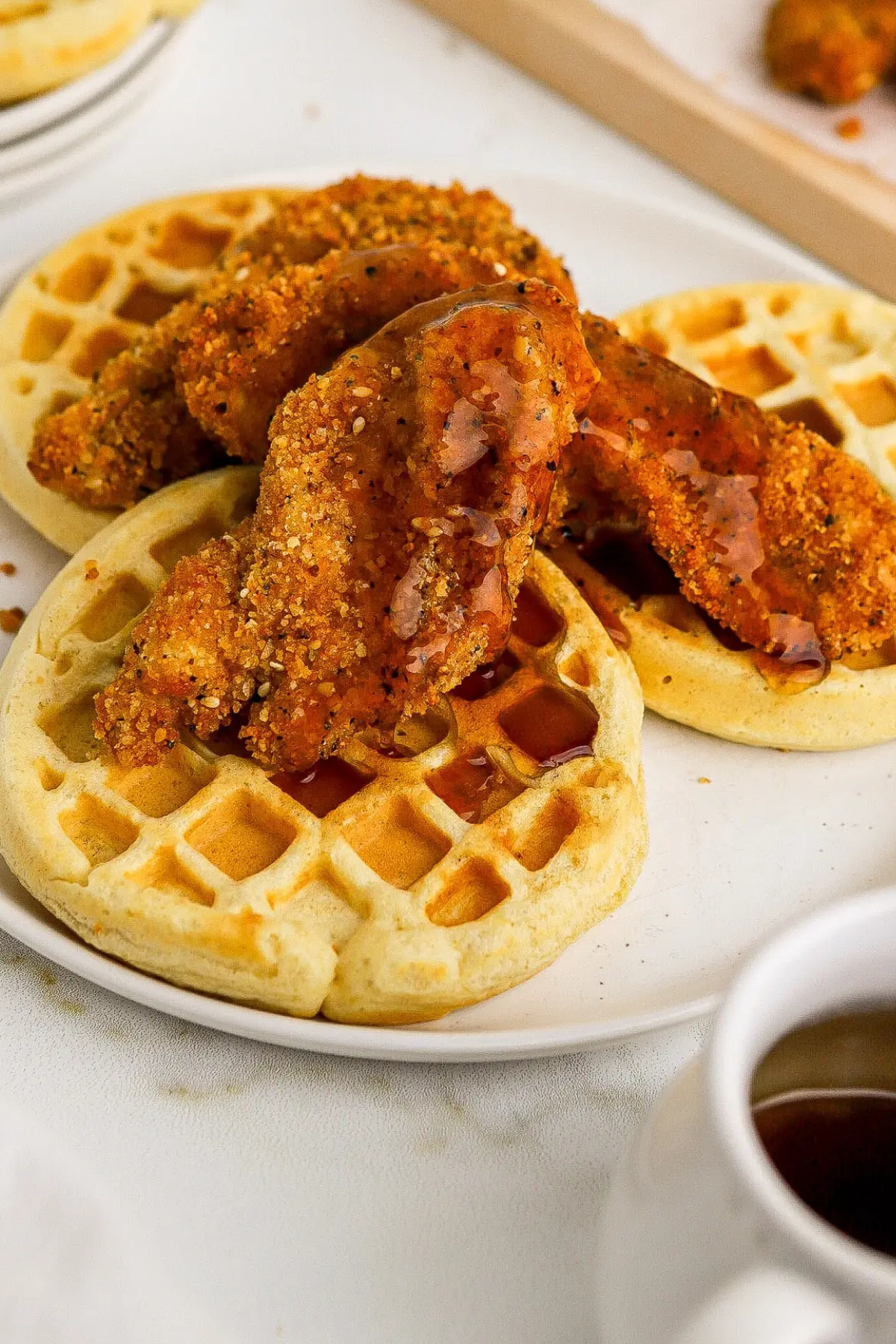 Chicken and waffles on plate.