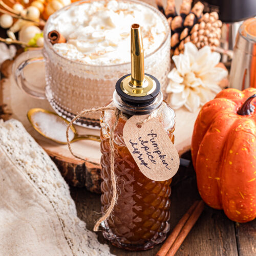 Pumpkin Spice Syrup on the table with a spice latte tank.