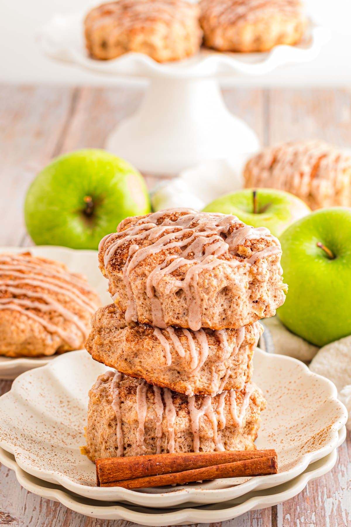 Apple Cinnamon Scones served on a plate dotted with a cinnamon stick.