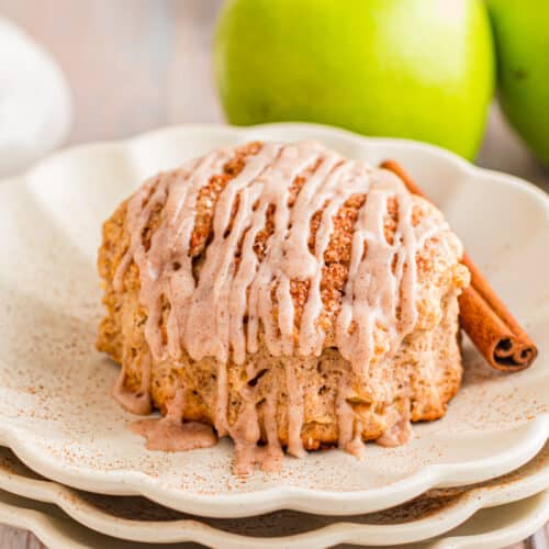 Apple Cinnamon Scones served with a spiced vanilla glaze on a plate.