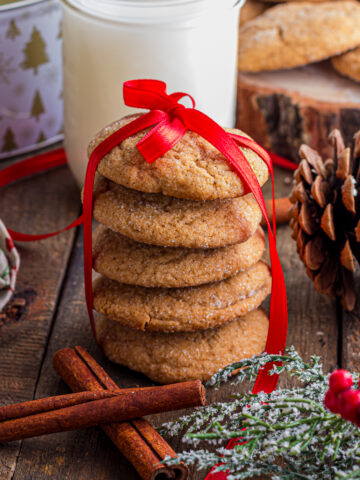 Gingersnap Cookies stacked and wrapped with a red satin ribbon.